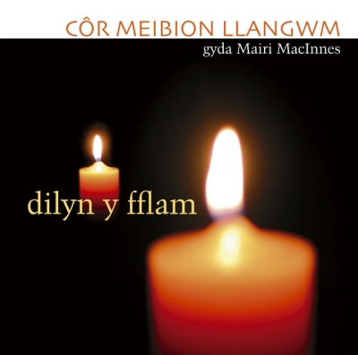 Two glowing candles, one large in the foreground and one smaller behind, sit against a black background beneath Welsh lettering.